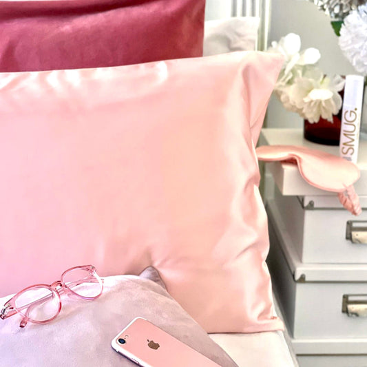 A pink satin SMUG pillowcase