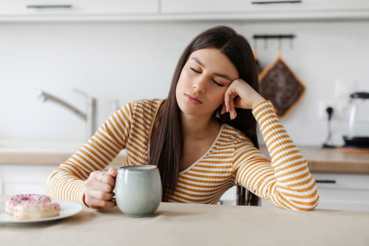 Tired woman drinking a coffee