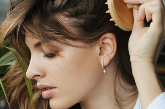 Woman using SMUG's bamboo scalp massager