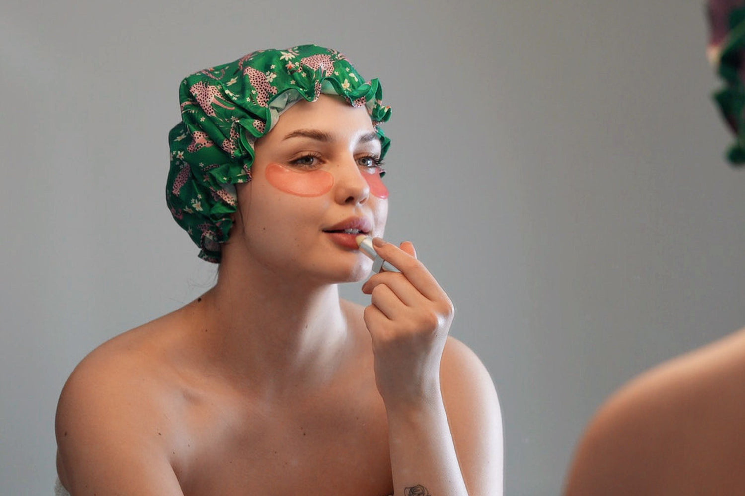Woman doing makeup wearing Smug 'Cheetah' Shower Cap