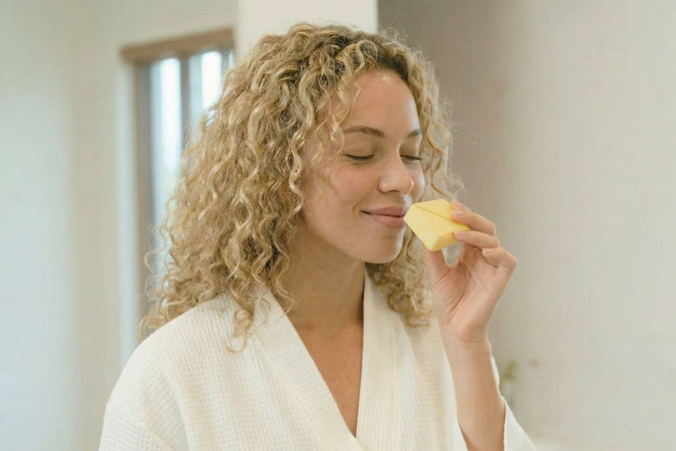 woman enjoying the scent of a shower steamer